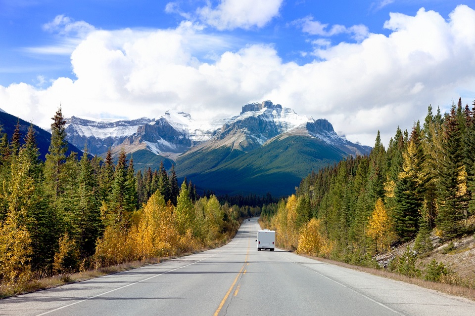 a motorhome drives twoards the rockies