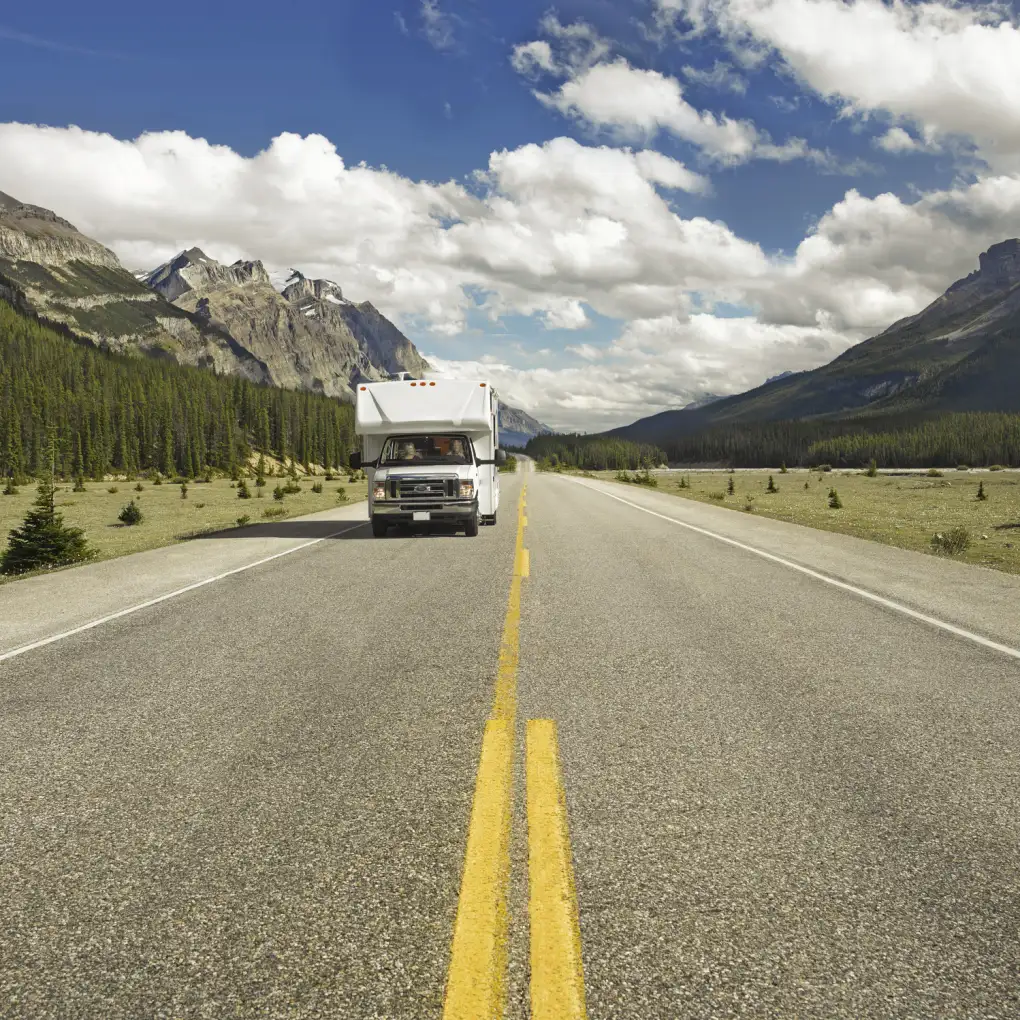 A motorhome drives along the Icefields Parkway in Canada