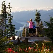 Mother and son are enjoying the views from a viewing platform along the Meadows in the Sky Parkway at Mount Revelstoke National Park