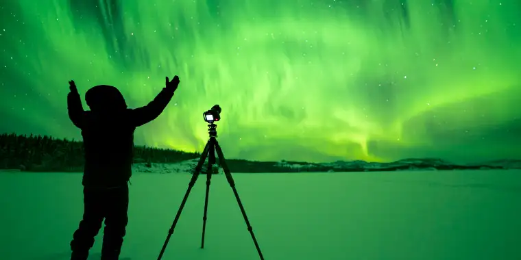 A man photographing the northern lights in Yukon